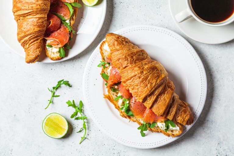 Croissant sandwich with cream cheese, salmon and arugula